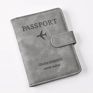 Close-up detail of grey PU leather passport wallet featuring a secure magnetic snap closure.