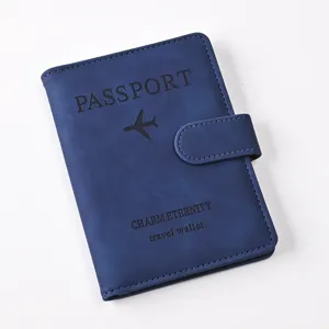 Blue PU leather passport holder detail, travel wallet with magnetic clasp and debossed logo.