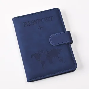 Detail view of blue PU leather passport holder featuring debossed world map and magnetic buckle.