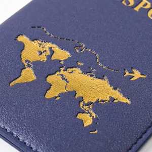 Close-up detail of a blue PU leather passport cover with gold hot-stamped world map.
