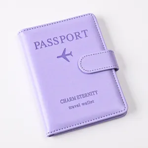 Detail view of the purple PU leather passport wallet with magnetic buckle and embossing.