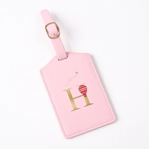 Pink leather luggage tag with gold letter H and hot air balloon print, travel suitcase ID badge