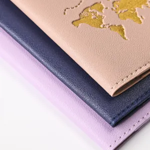 Close-up detail of stylish PU leather passport holders featuring gold foil world map embossing.