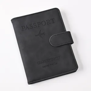 Black PU leather passport cover wallet with magnetic snap closure and embossed travel details.