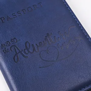 Blue PU leather passport cover with travel theme embossed text, durable travel wallet.