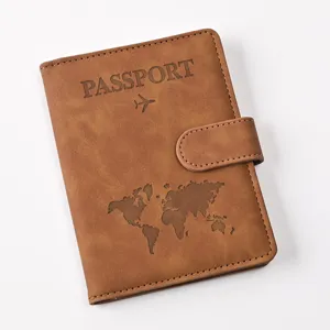 Detailed view of brown PU leather passport holder with magnetic snap and debossed map.