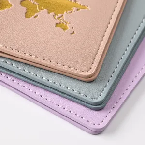 Close-up detail of multi-color PU leather passport holder with gold world map and neat white stitching.