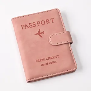 Pink PU leather passport holder with magnetic buckle and travel wallet design details.