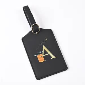 Black leather travel luggage tag with golden letter A design, ideal for suitcase identification.