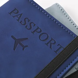 Close-up detail of blue PU leather passport holder with elastic band and embossed passport text.