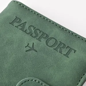 Detailed close-up of green PU leather passport holder featuring embossed text and magnetic snap.
