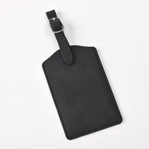 Black leather luggage tag with adjustable buckle strap, minimalist travel bag label identifier.