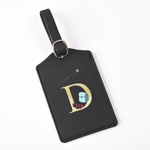 Black leather luggage tag featuring a gold letter D design, cute travel charms and durable strap.