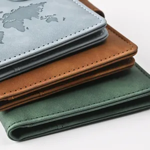 Detailed view of stacked PU leather passport holders featuring world map embossing and stitching.