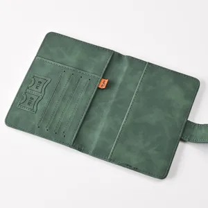 Detail view of dark green PU leather passport holder interior, featuring card slots and RFID tag.