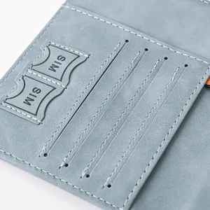 Light blue PU leather passport holder and card slot detail view with fine white stitching.