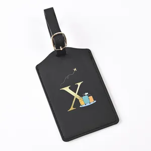 Black leather luggage tag with gold letter X and travel icon, durable strap for suitcases.