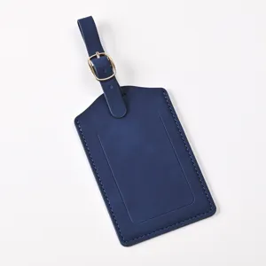 Dark blue PU leather luggage tag detail, elegant stitching and gold metal buckle.