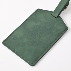 Dark green PU leather luggage tag detail view, durable travel accessory with metal buckle strap.