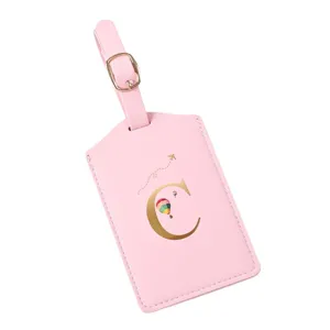 Pink leather luggage tag with gold letter C, cute travel suitcase identifier and ID label.