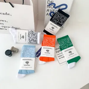 Trendy paisley bandana print crew socks for men and women, comfortable streetwear styles.