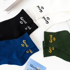 Close-up view of casual cotton short socks featuring knitted Good smiley face patterns in various colors.