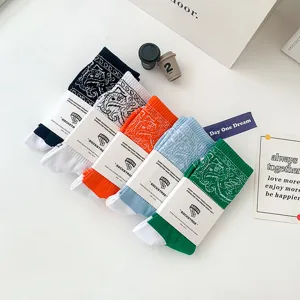Trendy paisley pattern long crew socks featuring comfortable cotton blend fabric for casual wear.