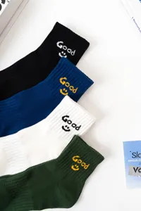Trendy cotton crew socks for men and women, featuring cute Good smiley face embroidery.