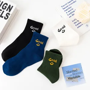 Unisex cotton mid-tube socks featuring embroidered good letters and cute smiley face design.