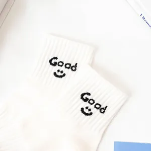 White cotton short socks featuring stylish Good letter and cute smiley face design.