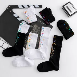 Detailed shot of splash ink sport socks, colorful splatter pattern and fake two-piece design.