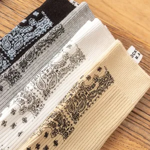 Detailed view of fashionable crew socks featuring classic paisley print in multiple colors.