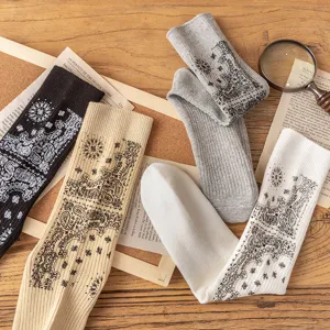 Detailed close-up of retro paisley print cotton crew socks with stylish ribbed design.