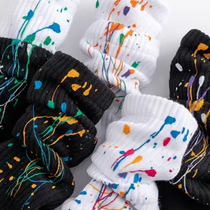 Close up detail view of black and white winter splatter paint fashion socks texture.