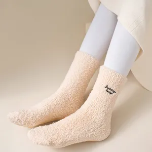 Cozy plush fuzzy warm winter socks with cute embroidered letter design for daily home wear comfort.