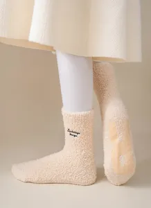 Cozy plush fuzzy crew socks with embroidery detail and anti-slip sole for women winter.