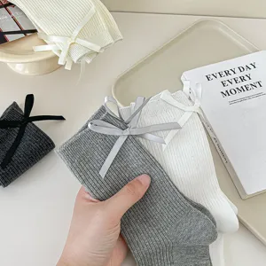 Women rib knit mid tube socks with cute back bow design, comfortable casual cotton socks style.