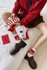 Festive red cotton mid-tube socks featuring cute puppy prints and classic stripes for New Year.