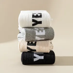 Comfortable solid color knit long socks with letter design, stylish casual sportswear.