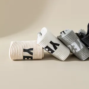 Close-up detail of rolled fashion socks with letter knit, soft fabric and neat display.