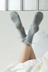 Grey cotton mid-calf socks with cute bow detail, soft and comfortable for daily wear.