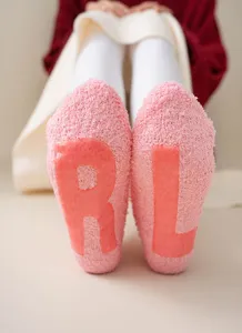 Cozy plush winter socks for women with anti-slip rubber letters, warm fleece casual mid-tube socks.