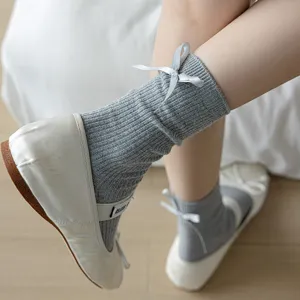 Grey ribbed mid-calf socks for women featuring a sweet back bow design for daily wear.