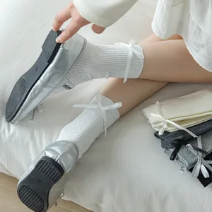 Women white mid tube slouch socks with cute side bows, soft cotton hosiery for daily wear.