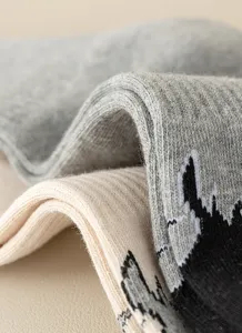 Comfortable knitted long socks featuring soft texture and stylish pattern, perfect for daily wear.