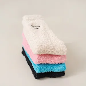 Close-up detail of soft fluffy fuzzy plush slouch socks in assorted colors stack.