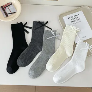 Women's ribbed mid-tube socks featuring a cute heel bow design. Thin cotton JK style hosiery.