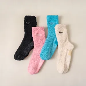 Cozy winter fuzzy socks with letter embroidery and anti-slip sole for daily warmth and comfort.