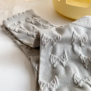 Grey cotton mid-tube socks with 3d relief bow patterns and sweet lace ruffle top edge.