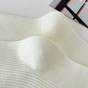 White knit socks fabric detail close-up view showing soft texture and fine ribbed knitted design